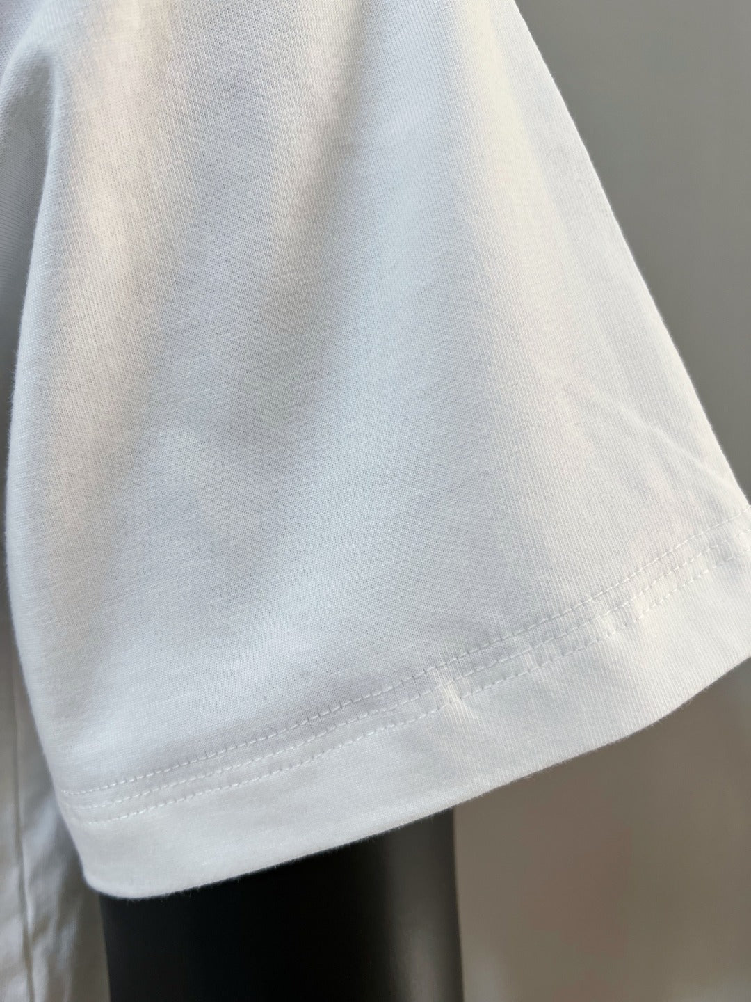 White T-shirt sleeve and hem close-up
