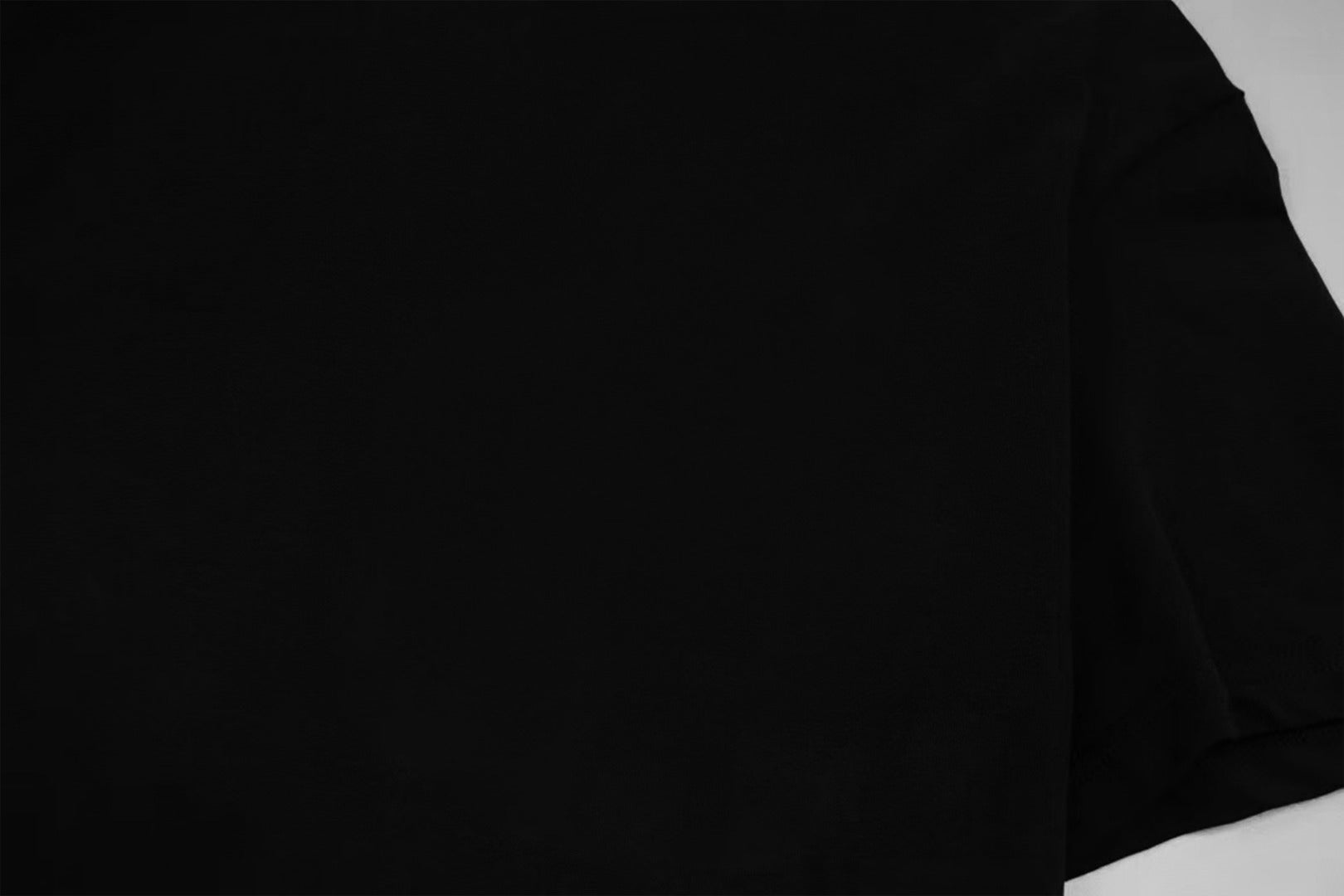 Givenchy dark black T-shirt sleeve and side seam close-up
