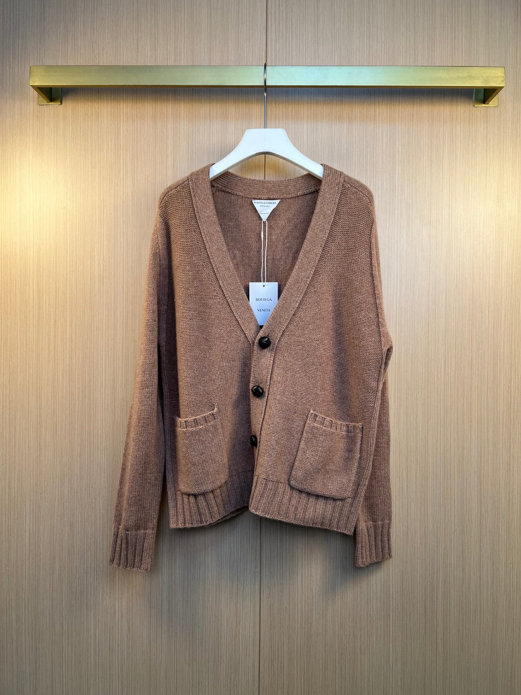 Brown knit cardigan with button front and V-neck, ribbed cuffs and hem