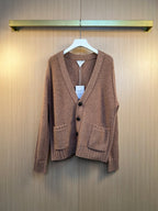 Brown knit cardigan with button front and V-neck, ribbed cuffs and hem