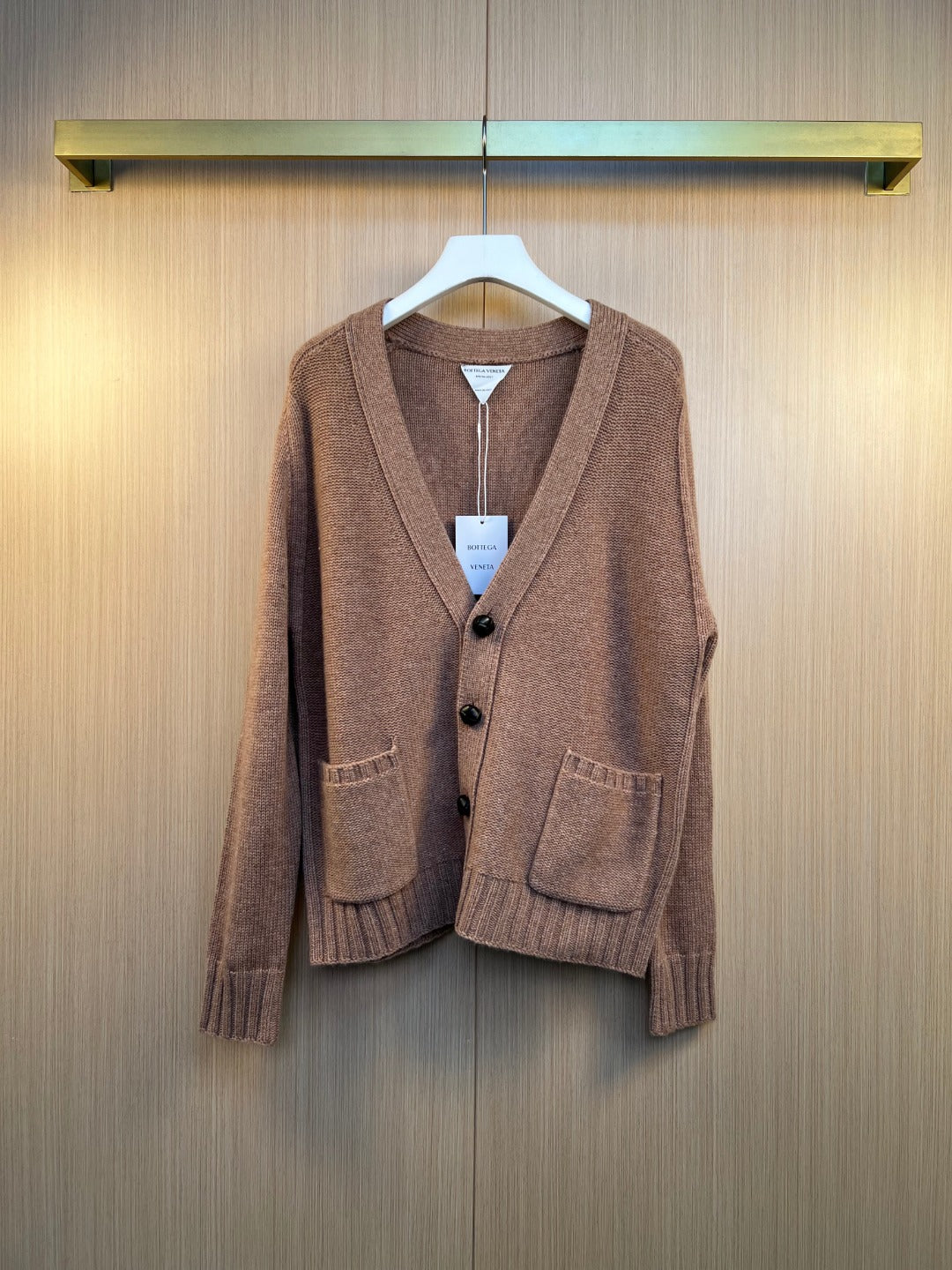 Brown knit cardigan with button front and V-neck, ribbed cuffs and hem