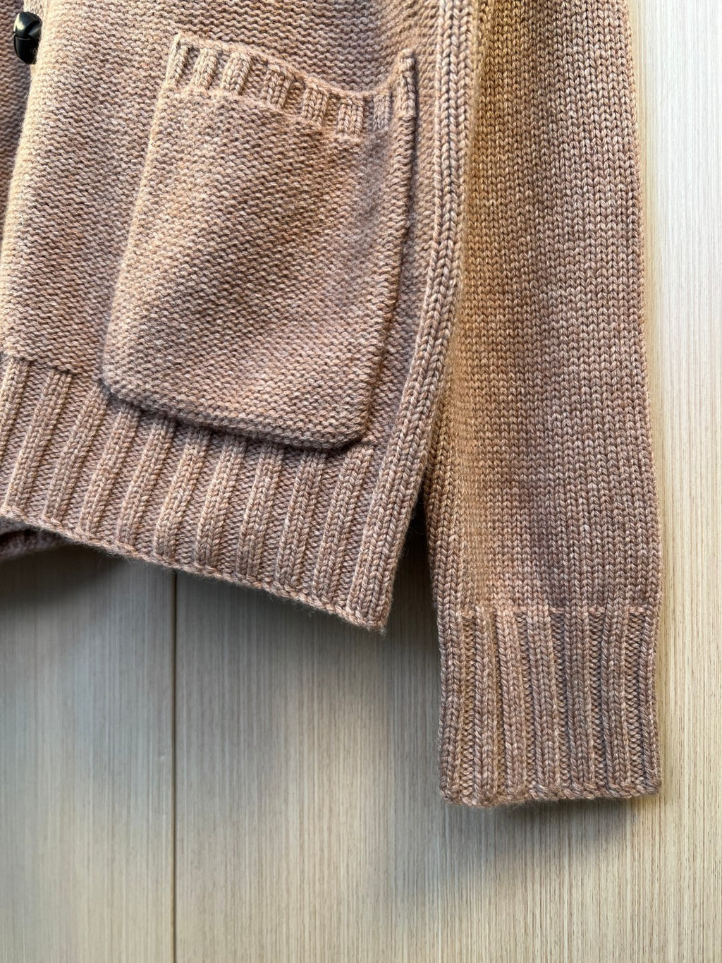Brown knit cardigan pocket detail and ribbed knit sleeve cuff