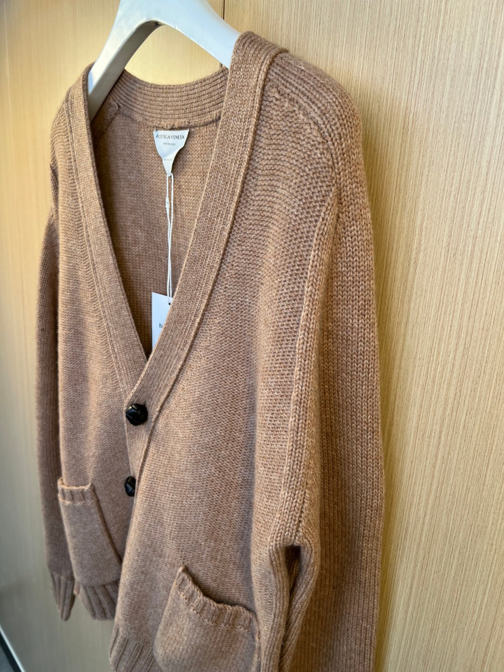 Brown knit cardigan with long sleeves, button front, and ribbed trim