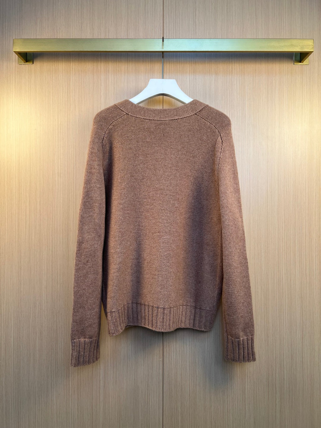 Brown knit cardigan back view with ribbed cuffs and hem