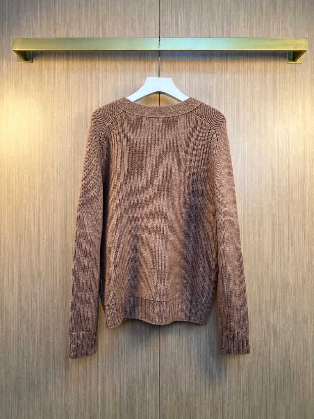 Brown knit cardigan back view with ribbed cuffs and hem