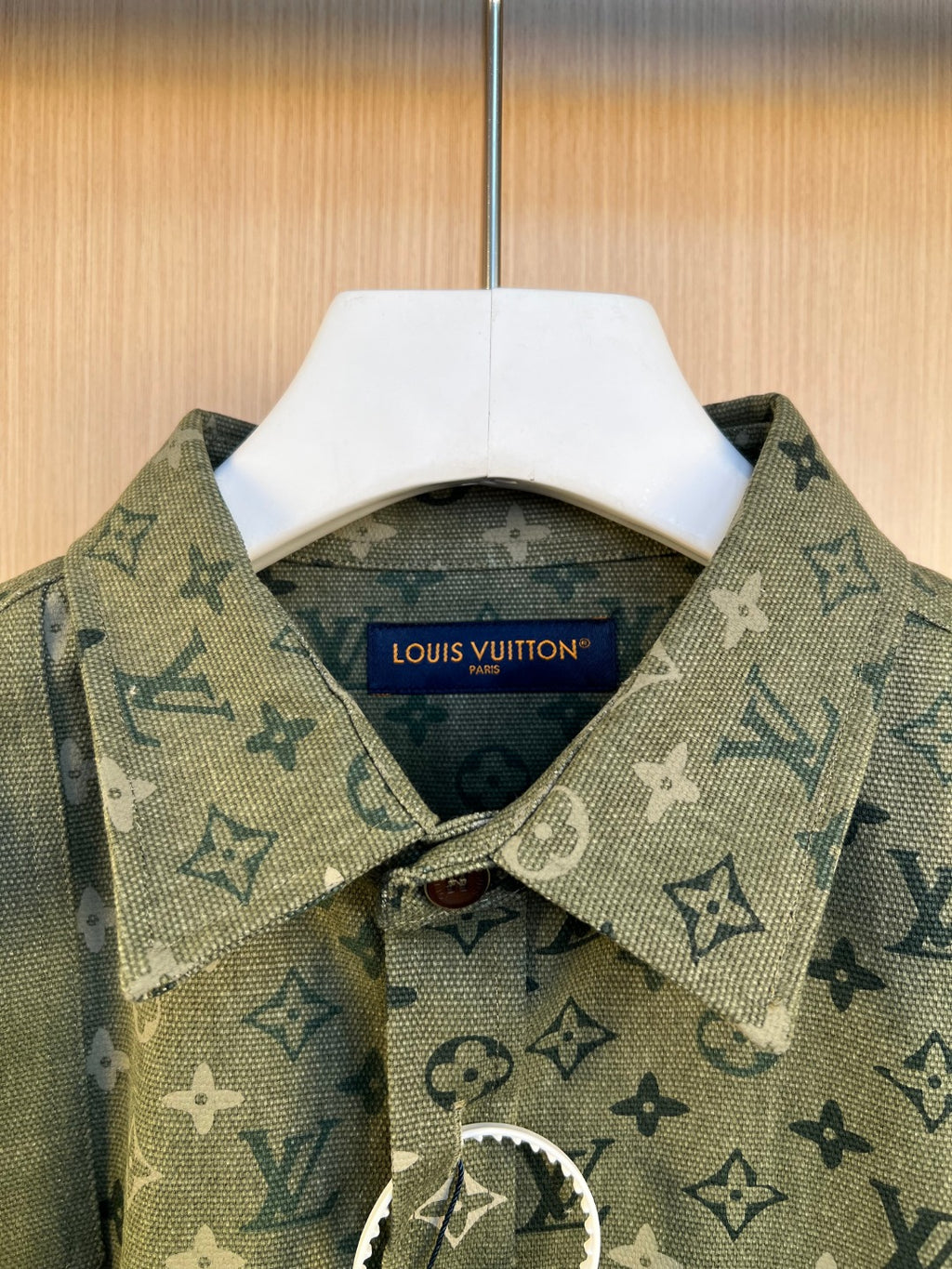 Long-sleeve shirt collar and placket in dark green monogram print with button and tag