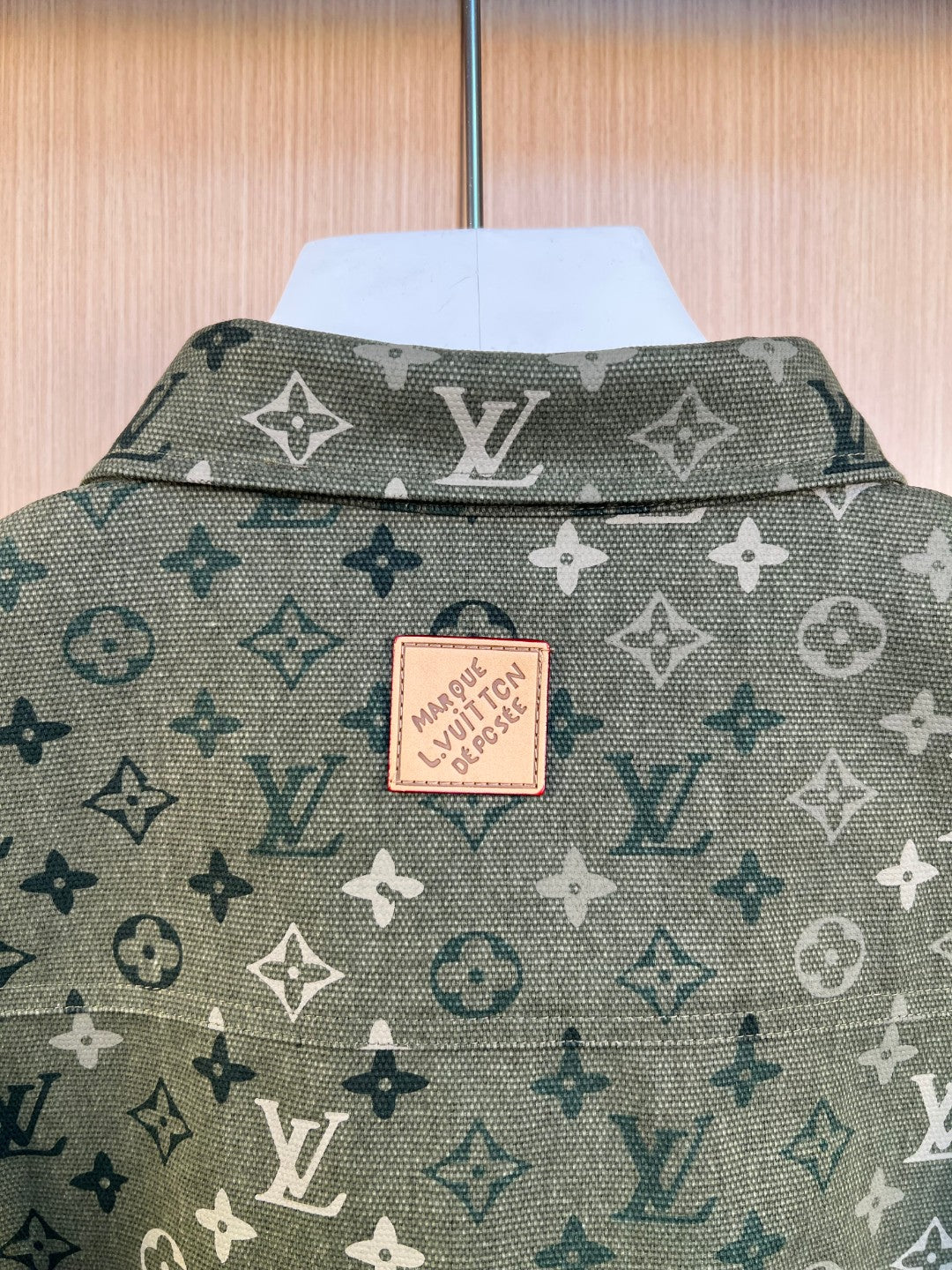 Shirt back neck label and patterned fabric in dark green with monogram print