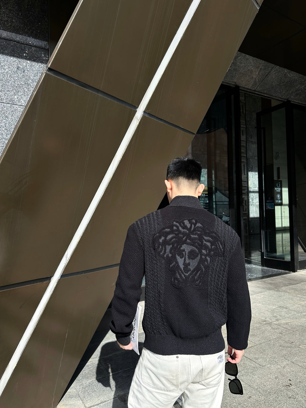 Black textured zip-up jacket with large back graphic, full-length zipper