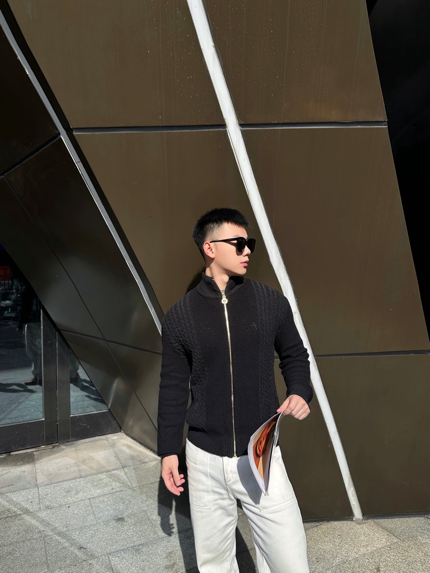 Black textured zip-up jacket with front zipper and stand collar