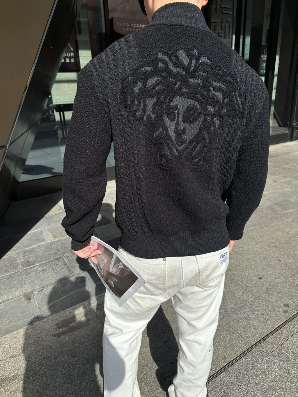 Black textured zip-up jacket with large back graphic, full-length zipper