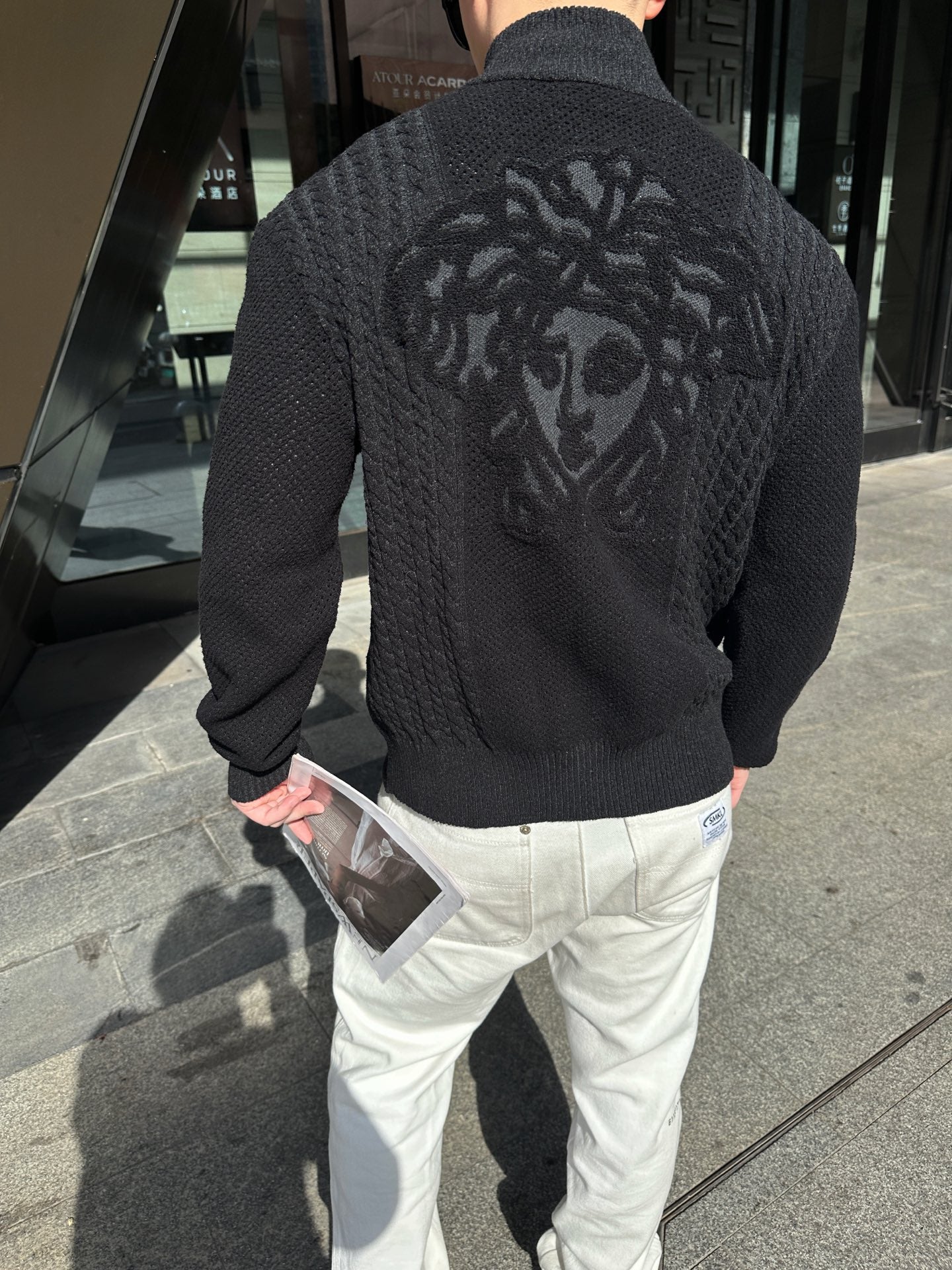 Black textured zip-up jacket with large back graphic, full-length zipper