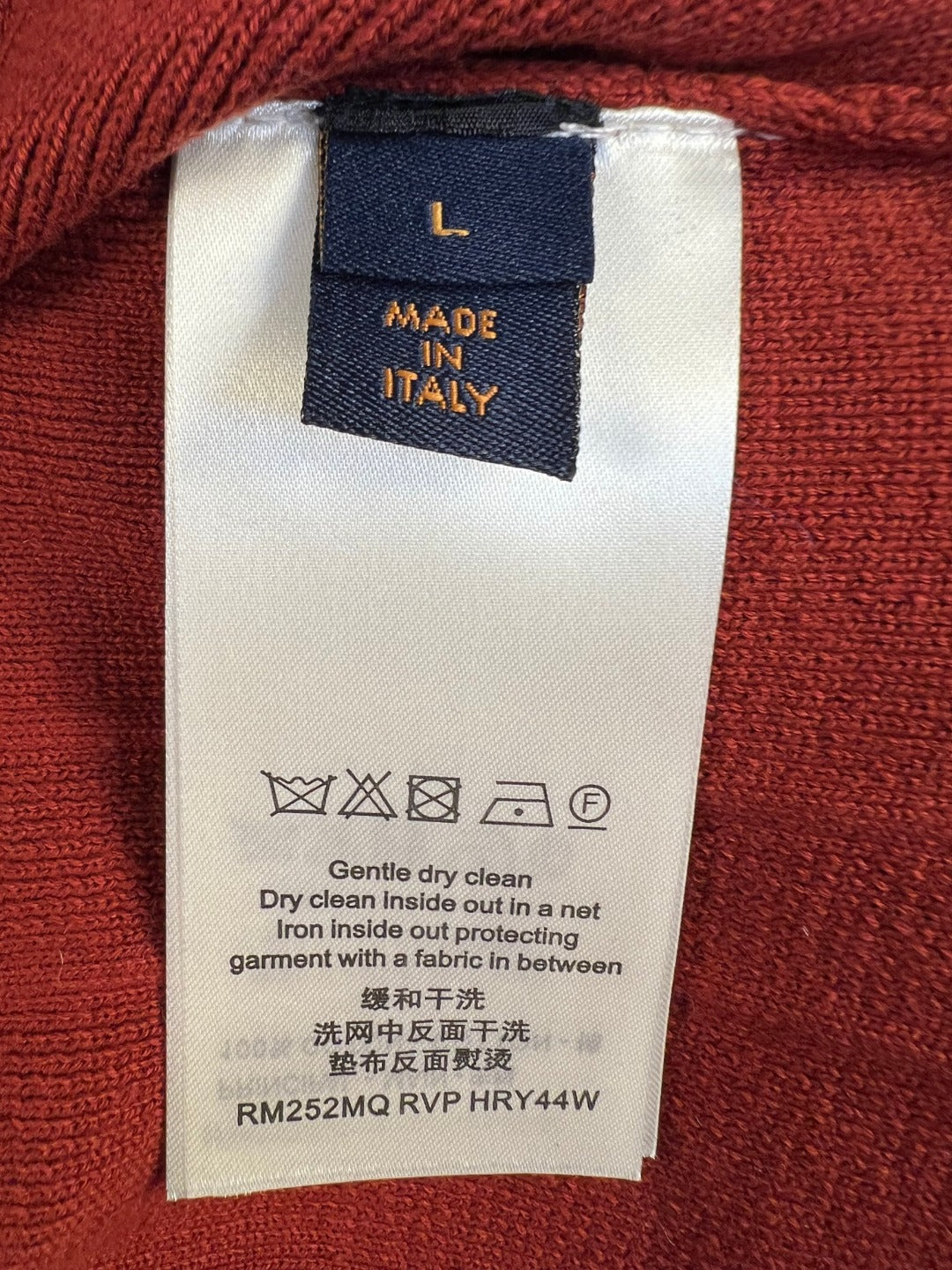 Louis Vuitton care and size label on rust red knit cardigan