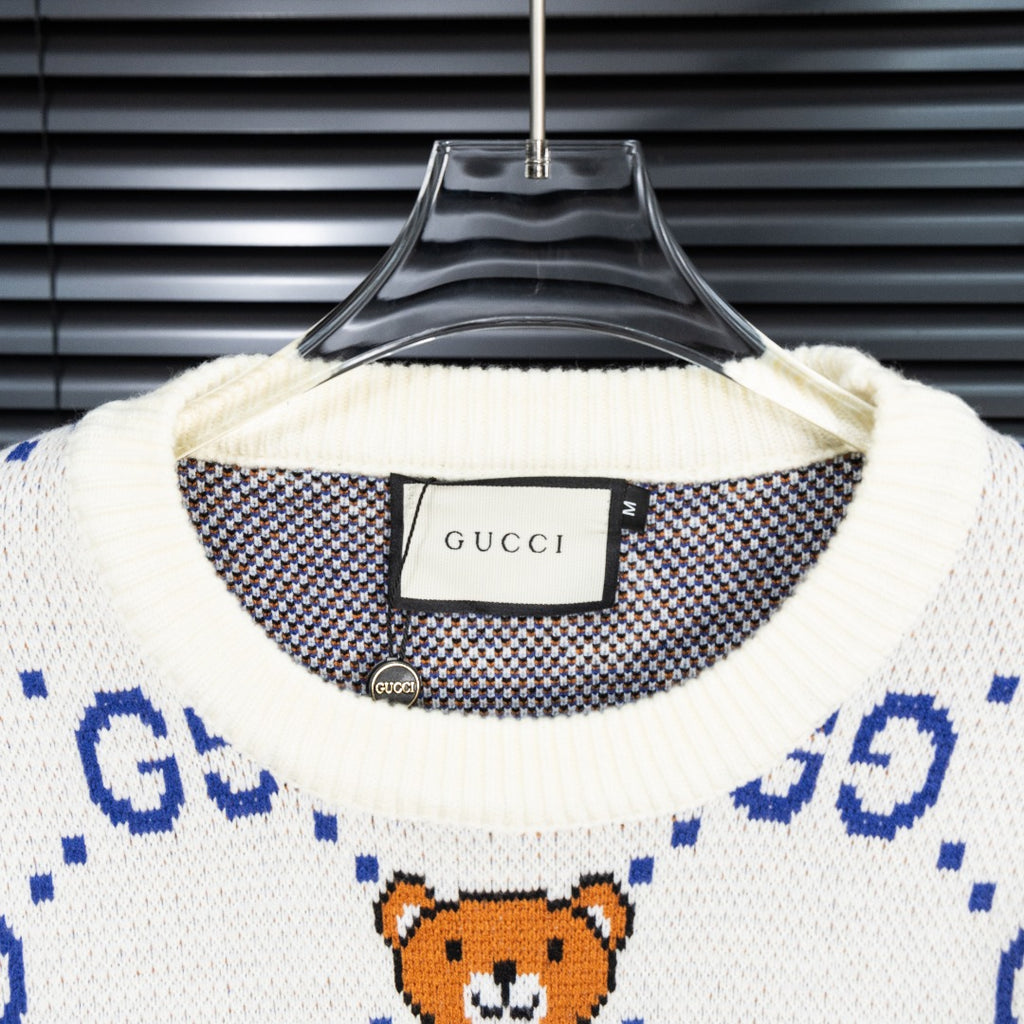 Gucci knit sweater collar with size tag and orange teddy bear patterned knit.