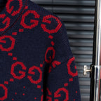 Navy knit long sleeve with red GG monogram pattern and ribbed cuff.