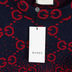 Gucci tag hanging on navy sweater with red GG monogram all-over pattern, crew neck.
