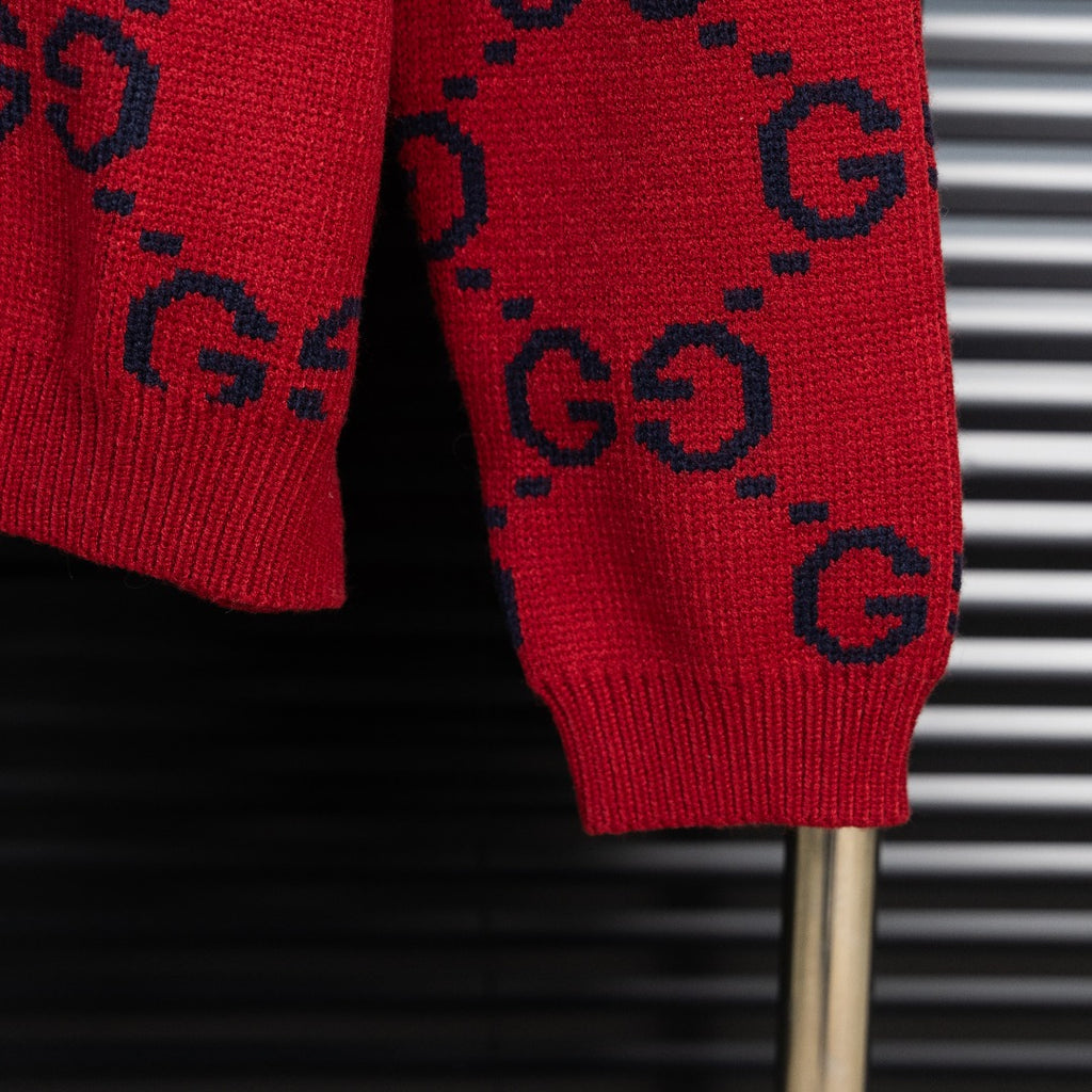 Red GG monogram knit sweater sleeve and ribbed hem cuff in dark navy.