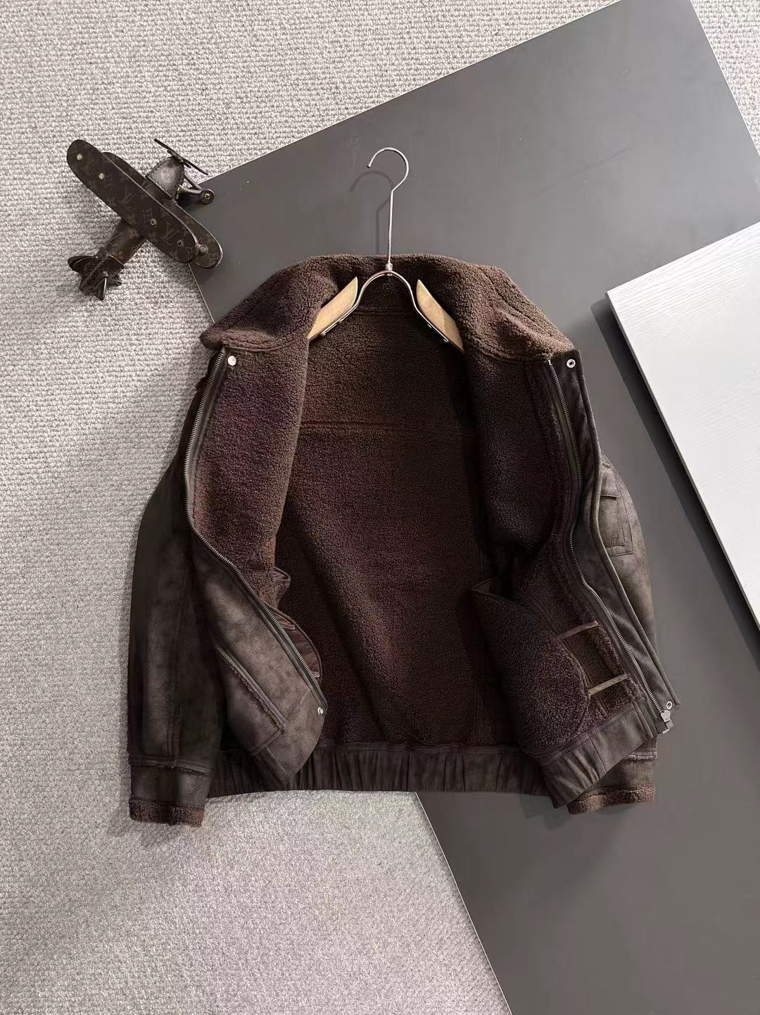 Brown shearling-collar jacket with inner lining and side zipper detail