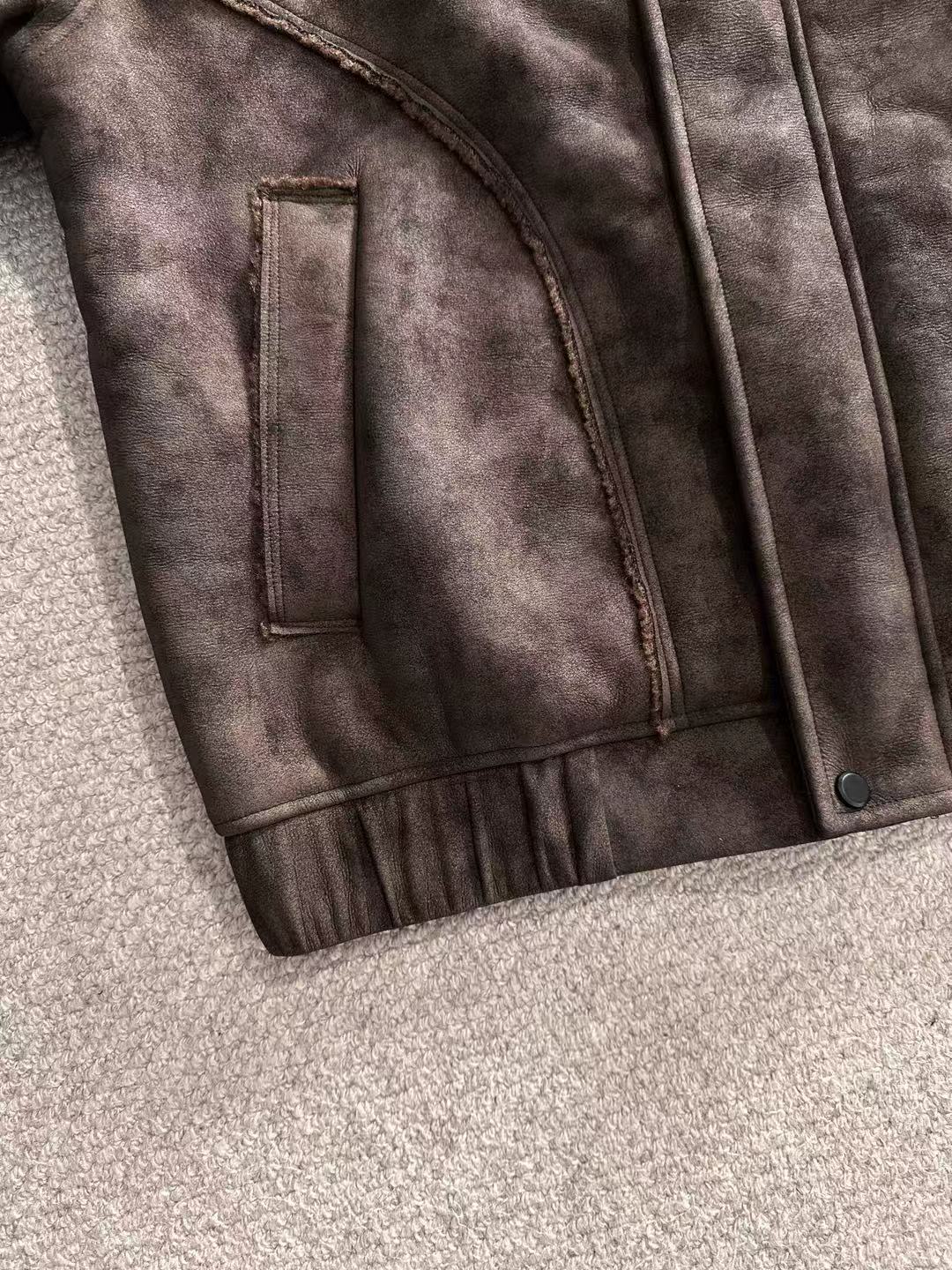 Brown jacket panel with vertical chest pocket and small metal button