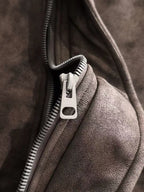Brown jacket zipper with metal pull and fleece-lined fabric edge