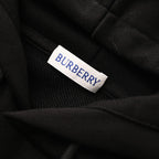 Black hoodie neck label reading BURBERRY on fabric.