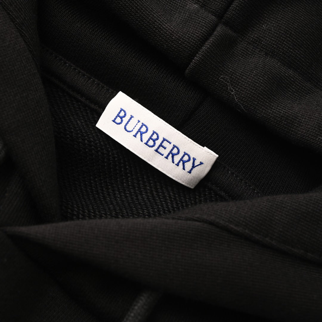 Black hoodie neck label reading BURBERRY on fabric.
