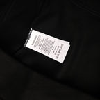 Black hoodie care label tag with BURBERRY branding and symbols.