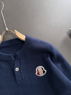 Moncler knit pullover close-up: ribbed henley collar and logo patch