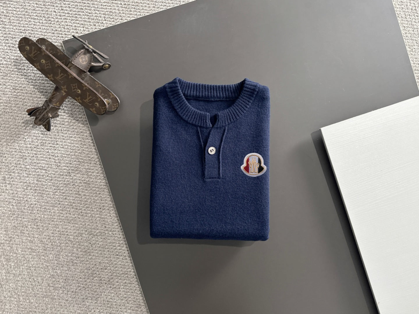 Moncler navy knit pullover front view with button placket and logo patch