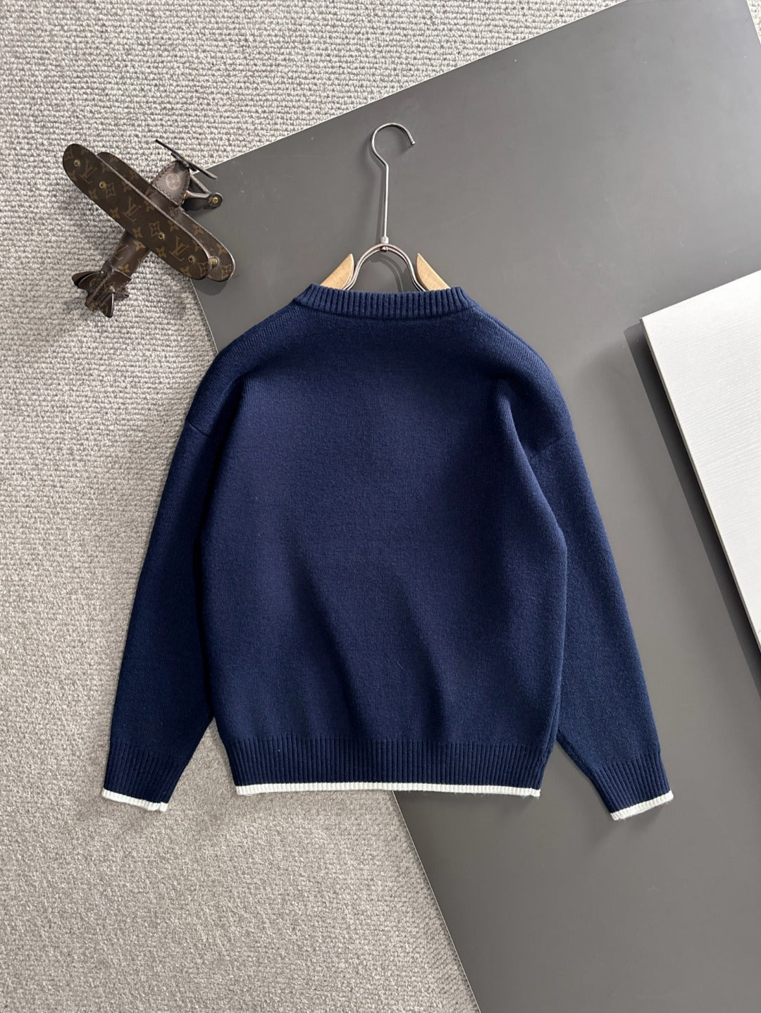 Moncler navy knit pullover back view on hanger