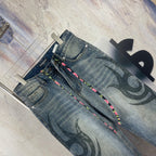 Blue denim pants, back view, with black graffiti print and multicolor drawstring