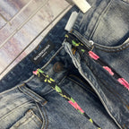 Blue denim pants front detail: multicolor braided drawstring and Balenciaga label