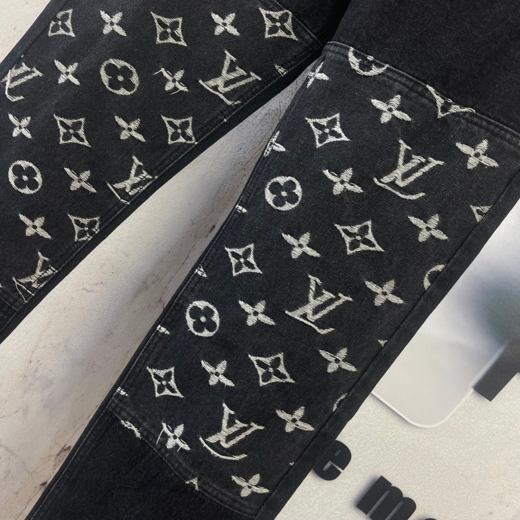 Black denim pants with white Louis Vuitton monogram pattern across both legs