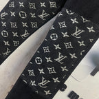 Black denim pants with white Louis Vuitton monogram pattern across both legs