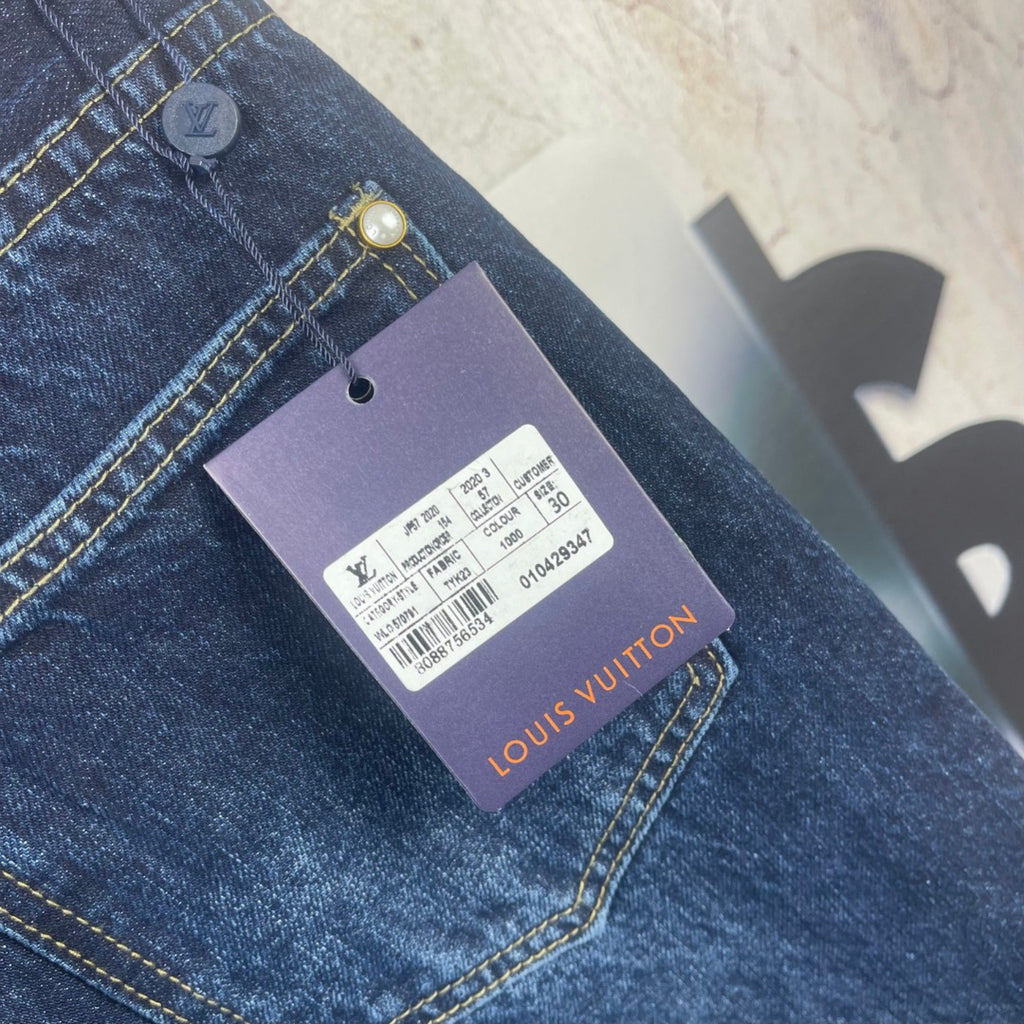 Louis Vuitton denim pants with brand tag attached to front pocket