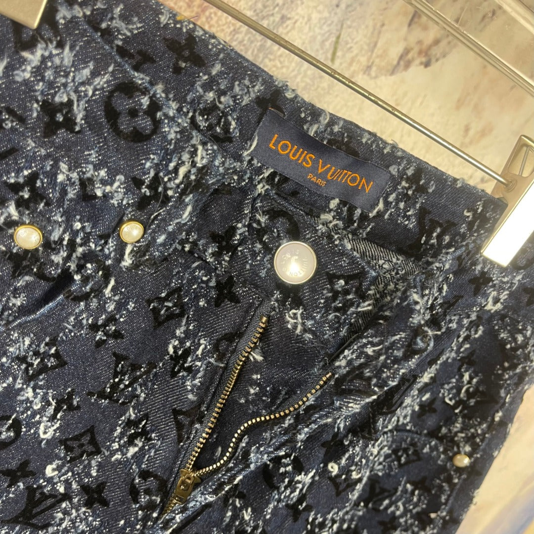 Louis Vuitton pants detail, dark blue patterned fabric with gold buttons