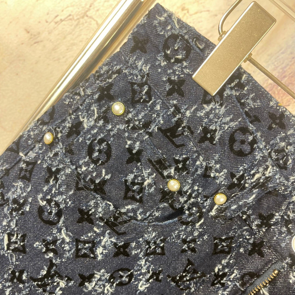 Louis Vuitton pants front detail, dark blue allover print with gold buttons