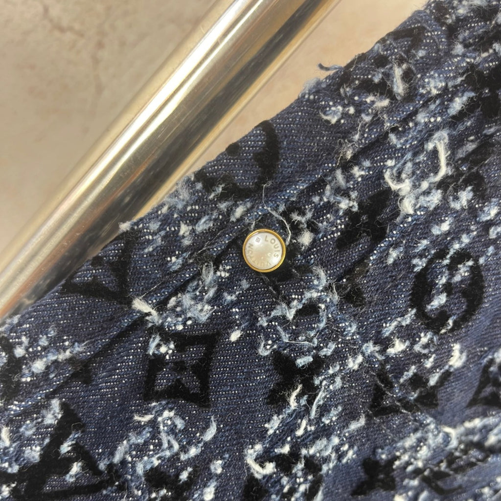 Louis Vuitton pants waistband detail, dark blue patterned fabric with button