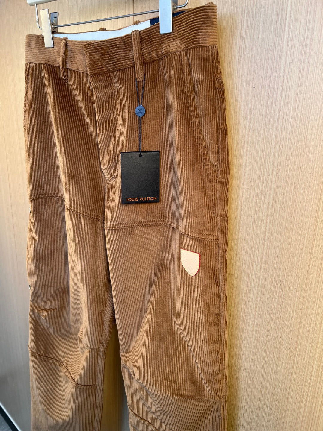 Corduroy pants with hanging Louis Vuitton tag, dark brown