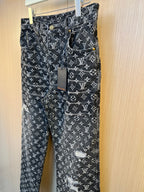 Louis Vuitton pants front view with monogram print, gold buttons, and patch detail