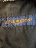 Louis Vuitton pants brand label on inner waistband, blue fabric with yellow text