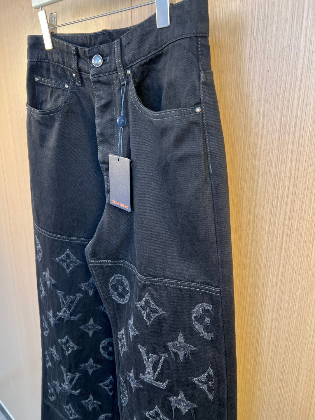 Dark denim pants with monogram embroidery on lower leg and side pocket
