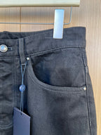Dark denim pants waist with belt loops, button, and zip fly