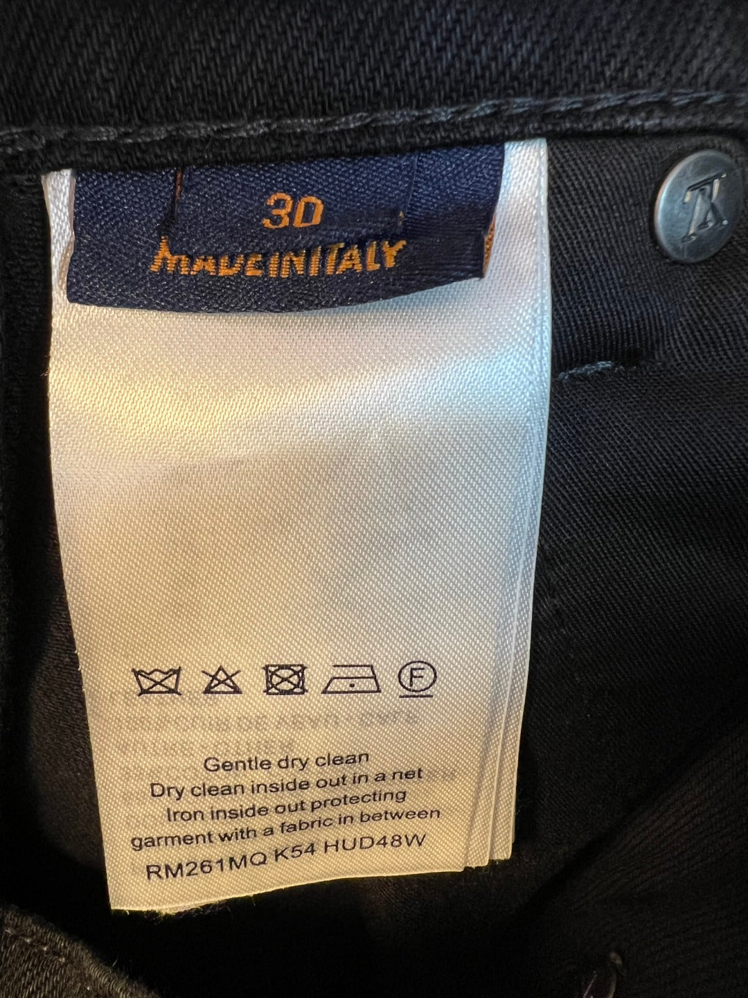 Denim pants care label with wash and cleaning icons