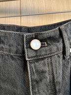 Denim waistband with button closure and circular LV logo badge.