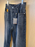 Dark denim pants hanging display with front and coin pocket panels.