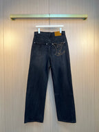 Dark denim pants with front pockets and LV logo patch at hip.