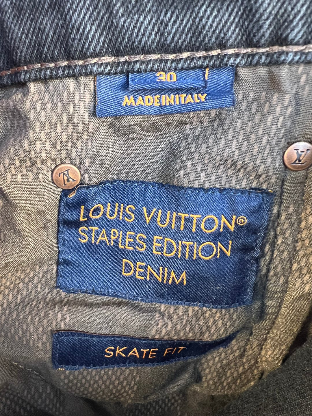 Inside denim label reading “Louis Vuitton Staples Edition Denim” and “Skate Fit”.
