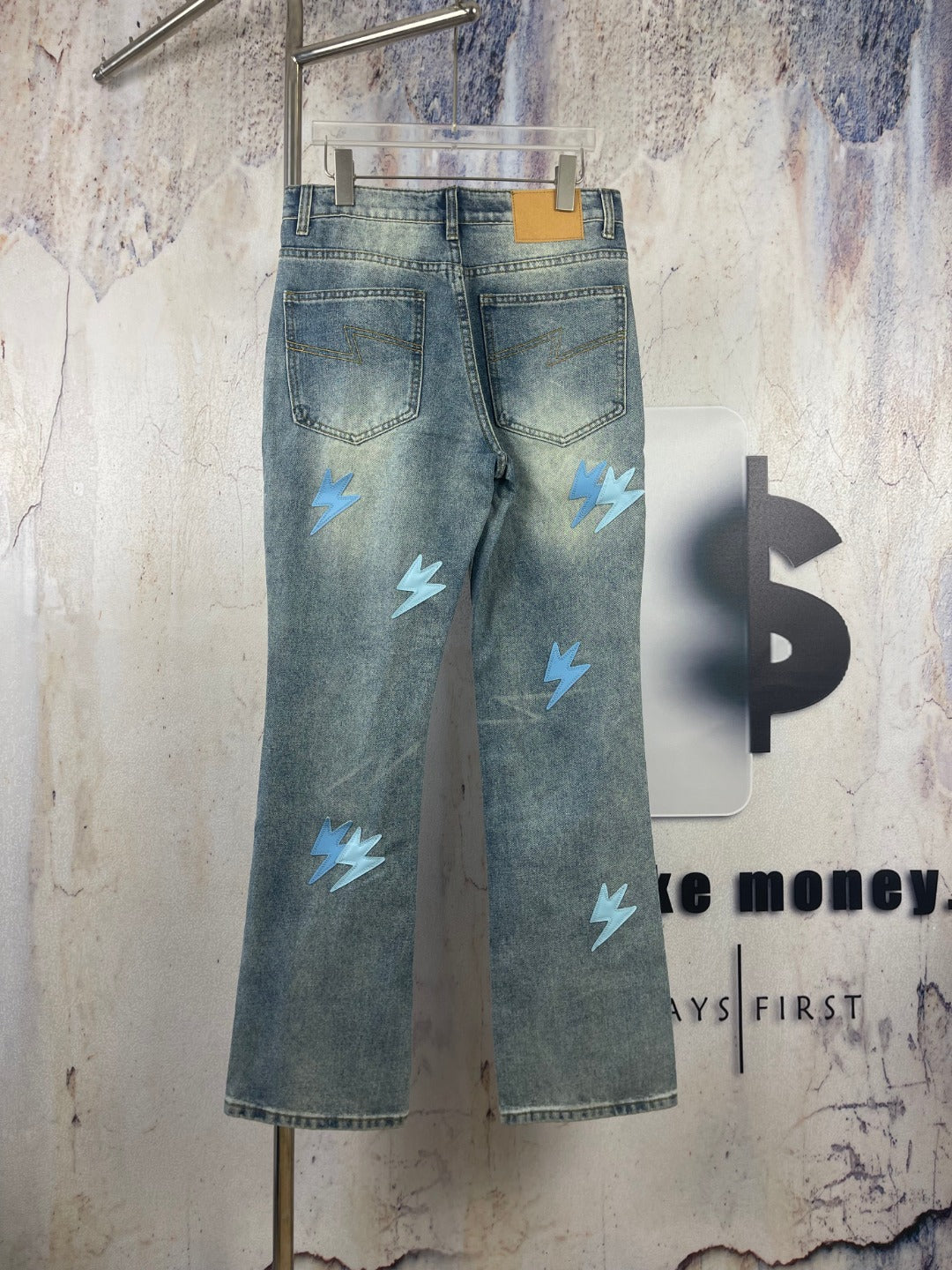 Light blue denim jeans with light blue lightning patches, back pockets and yoke