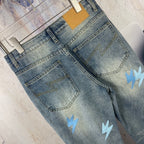 Light blue denim jeans back pockets with light blue lightning patches, folded view