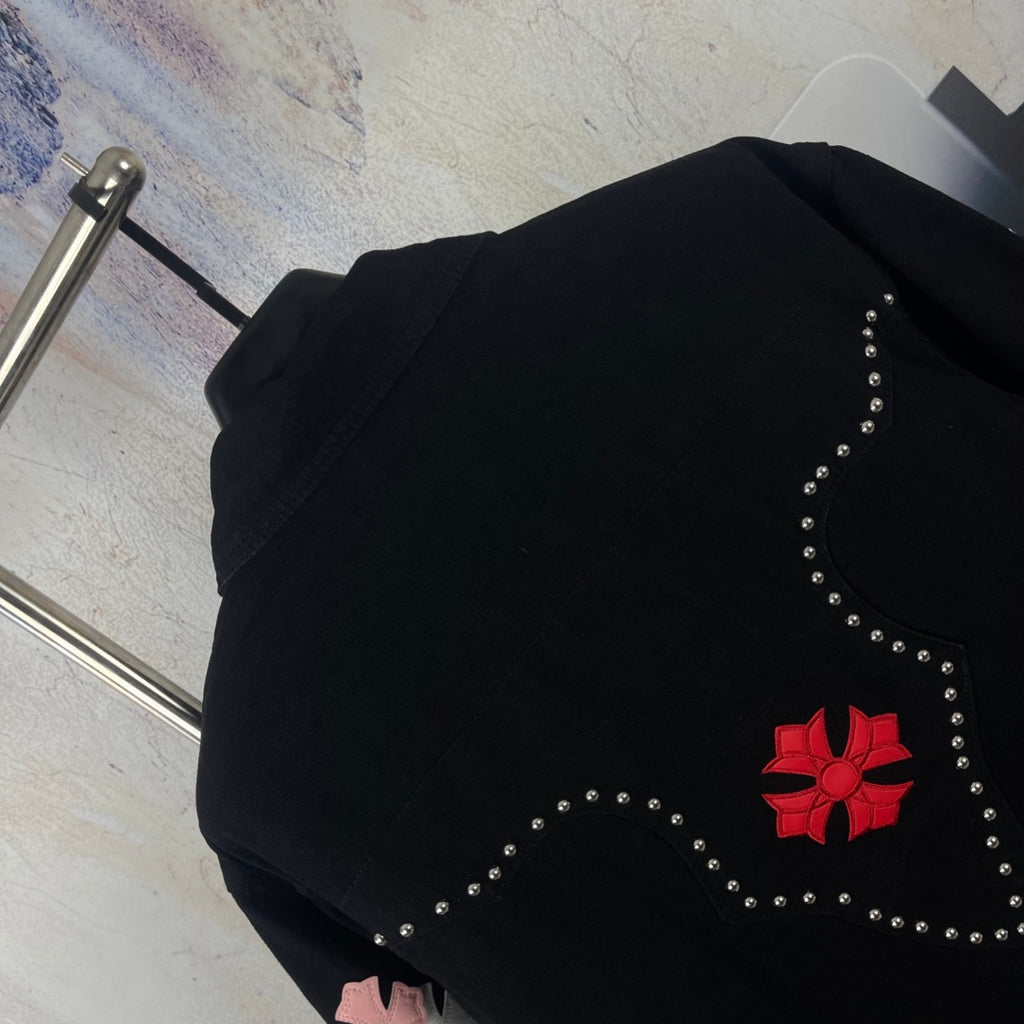 Black long-sleeve denim jacket back with red star-heart emblem and rhinestone stripes